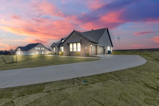 view of front of house with a garage and a yard