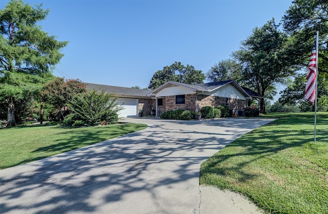 ranch-style house featuring a front yard and a garage