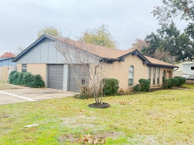 view of property exterior with a lawn and a garage