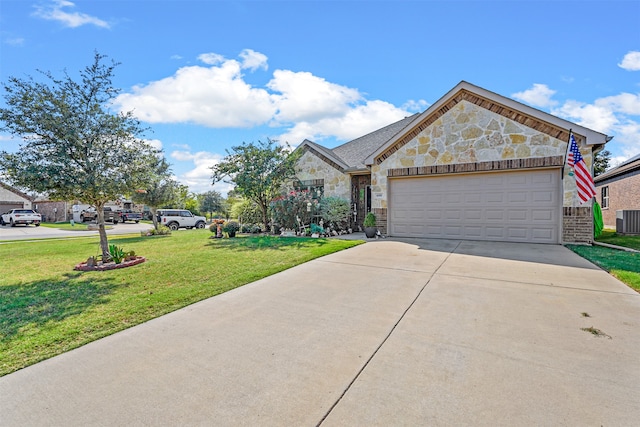 view of front facade featuring a garage, cooling unit, and a front lawn