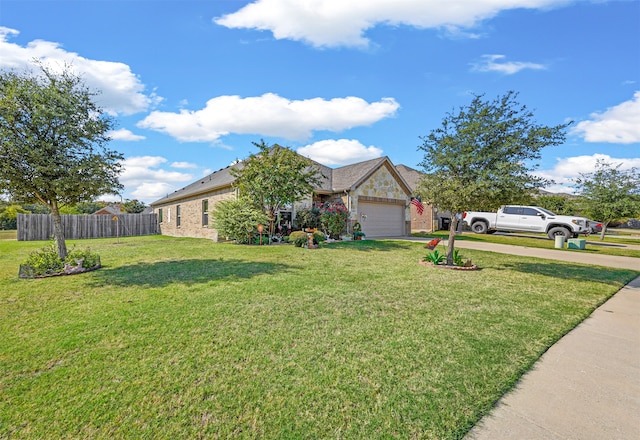 ranch-style house featuring a front yard and a garage