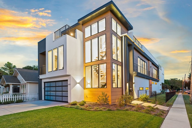 view of front of house with a garage and a yard