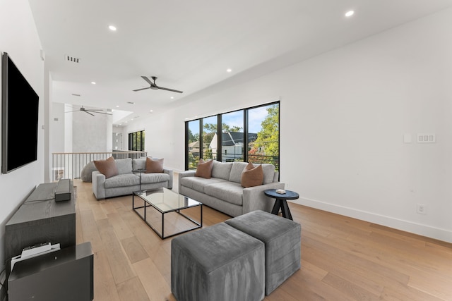 living room featuring ceiling fan and light wood-type flooring