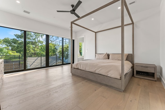 bedroom featuring ceiling fan, light hardwood / wood-style floors, and access to outside