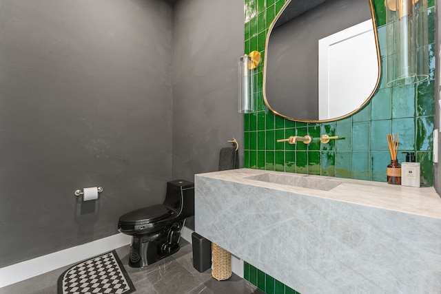 bathroom with sink, tile walls, toilet, and tile patterned floors