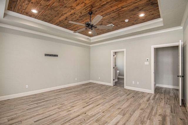 empty room featuring ceiling fan, a tray ceiling, wooden ceiling, crown molding, and light hardwood / wood-style floors