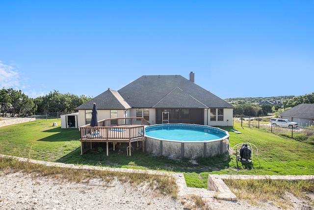 view of swimming pool with a yard and a deck