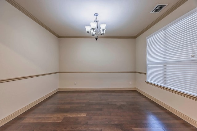 spare room with a notable chandelier, ornamental molding, and dark hardwood / wood-style flooring