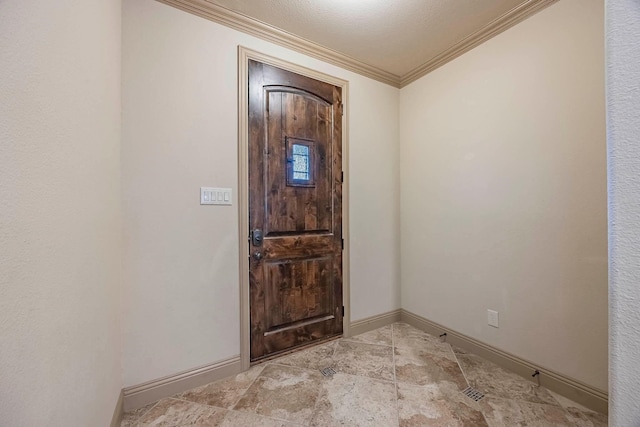 foyer featuring a textured ceiling and crown molding