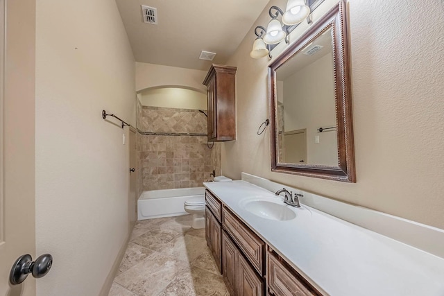 full bathroom with vanity, tiled shower / bath combo, and toilet