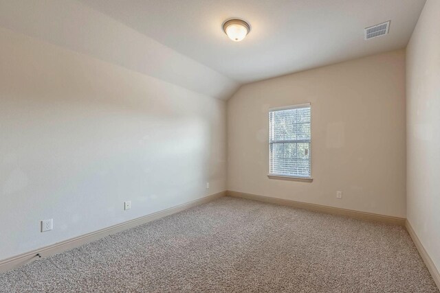 941 Lake Meadow Ln, Little Elm, TX 75068 - spare room with baseboards, visible vents, light carpet, and lofted ceiling