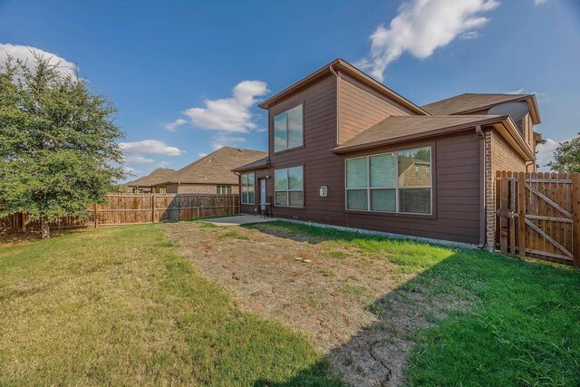 941 Lake Meadow Ln, Little Elm, TX 75068 - back of house featuring a lawn, a gate, and a fenced backyard