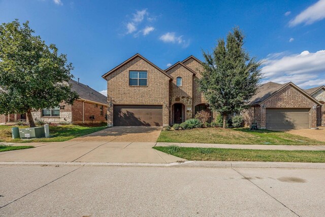 941 Lake Meadow Ln, Little Elm, TX 75068 - traditional-style house with brick siding, a front lawn, and concrete driveway