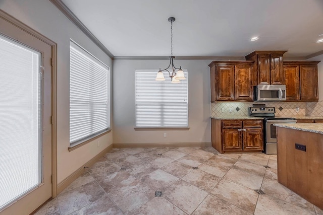 kitchen with light stone counters, ornamental molding, an inviting chandelier, appliances with stainless steel finishes, and decorative light fixtures