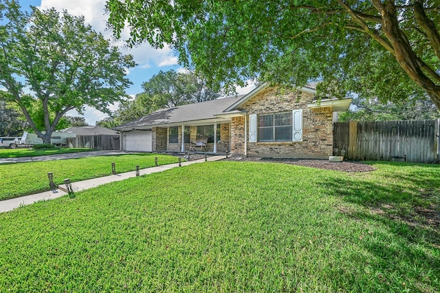 ranch-style house featuring a garage and a front yard