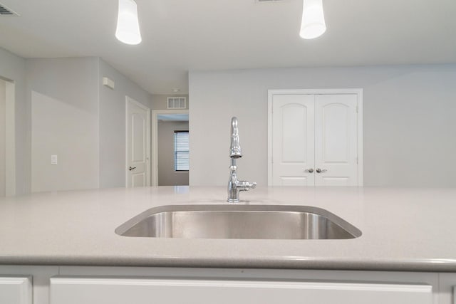 kitchen featuring decorative light fixtures and sink