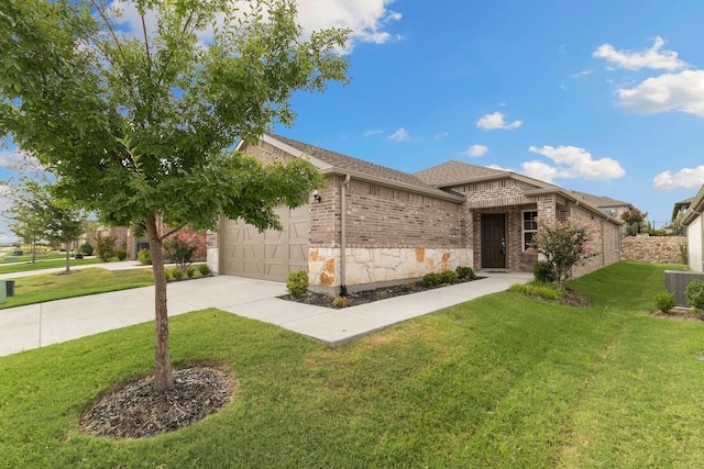 view of front of home featuring a garage, cooling unit, and a front yard