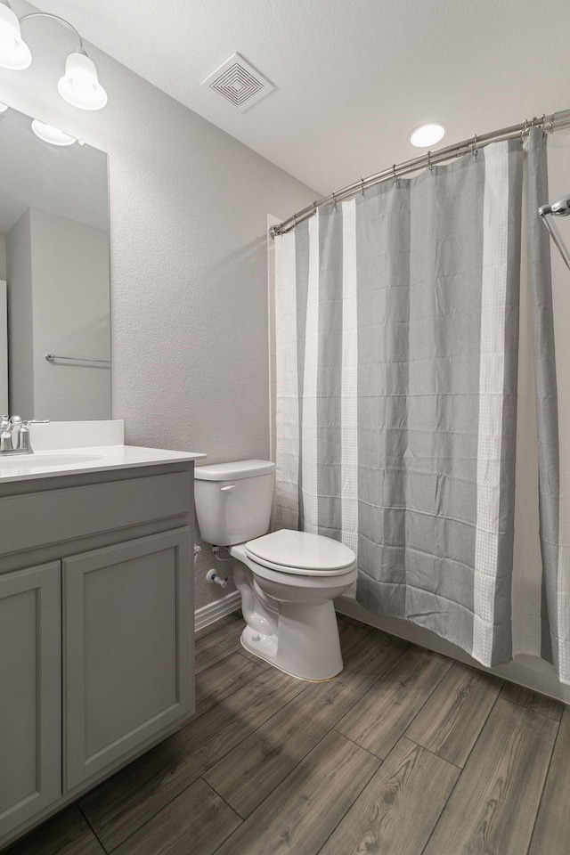 bathroom with toilet and vanity