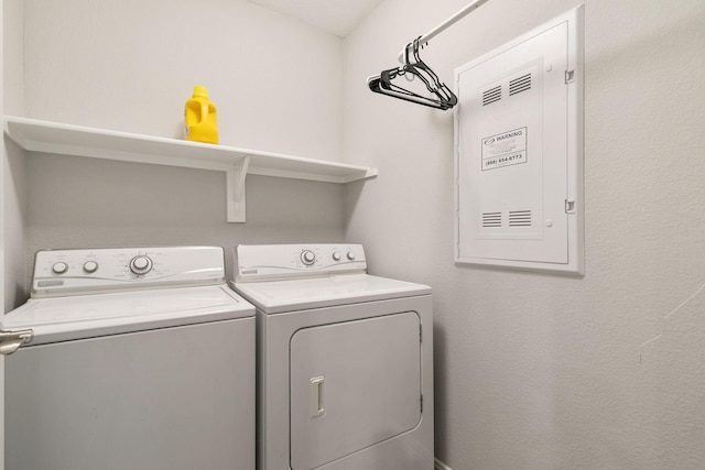 clothes washing area featuring washer and clothes dryer