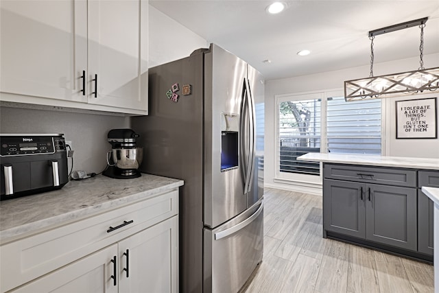 kitchen with hanging light fixtures, gray cabinetry, white cabinetry, and stainless steel refrigerator with ice dispenser