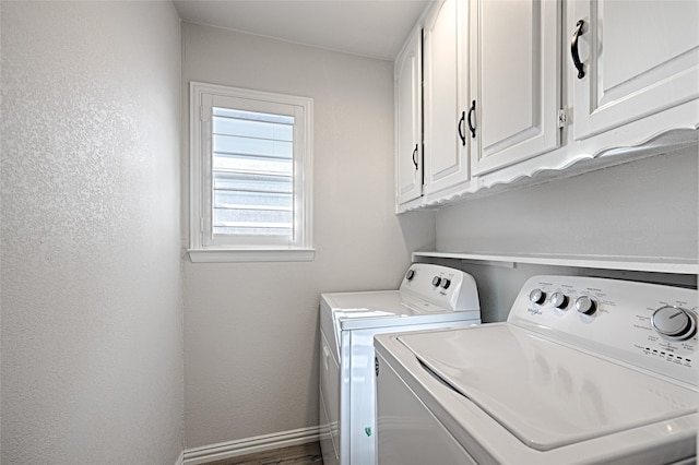 laundry area featuring independent washer and dryer, dark hardwood / wood-style floors, and cabinets