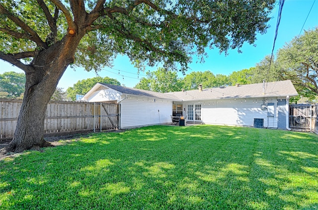 back of property with a lawn