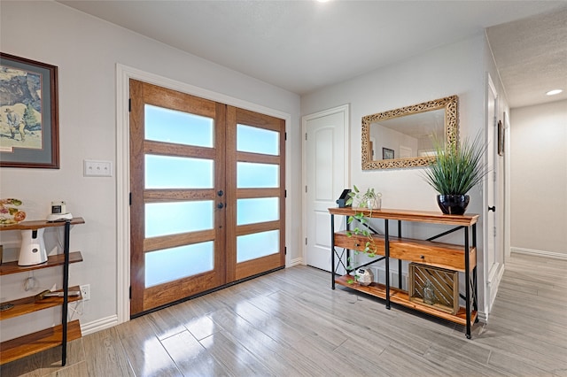 entrance foyer with french doors and light wood-type flooring