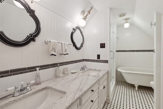 bathroom featuring vanity, tile walls, tile patterned floors, vaulted ceiling, and shower with separate bathtub