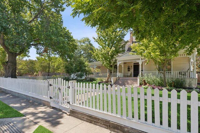 view of front of house with a front yard and covered porch