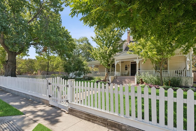 victorian home featuring a porch, a front lawn, and a shingled roof