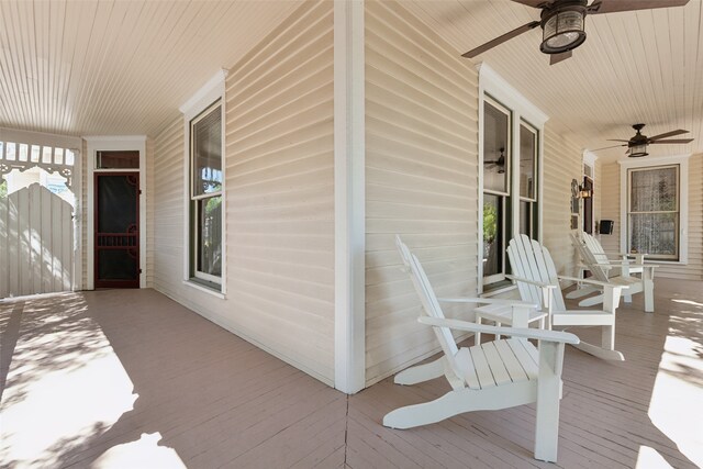 deck with a porch and ceiling fan