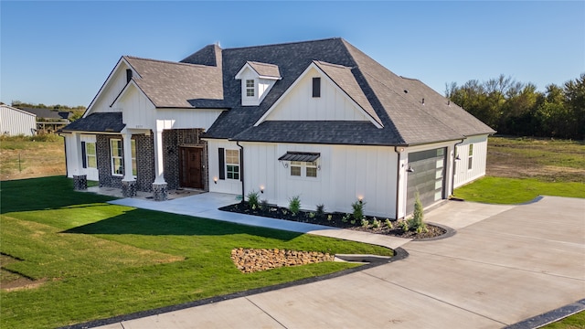 modern inspired farmhouse featuring a front yard and a garage