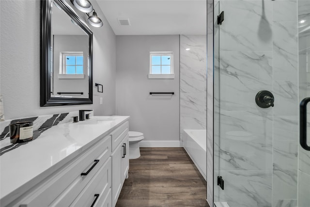 full bathroom featuring toilet, hardwood / wood-style floors, vanity, and separate shower and tub