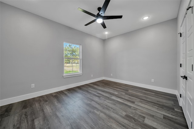 unfurnished bedroom featuring ceiling fan and dark hardwood / wood-style floors