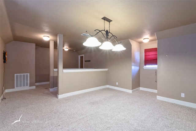 carpeted spare room featuring lofted ceiling