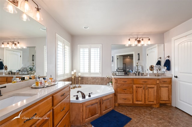 bathroom featuring vanity, a bathtub, and tile patterned floors