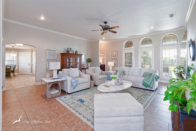 tiled living room with crown molding and ceiling fan