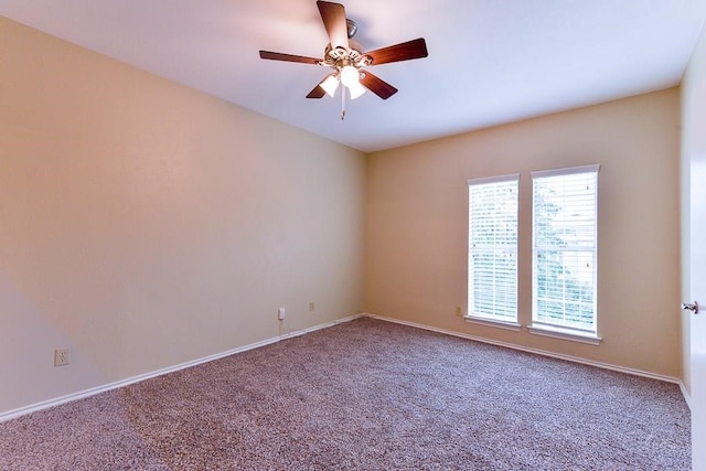 carpeted spare room featuring ceiling fan