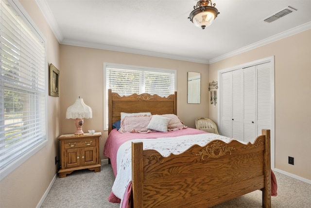 bedroom featuring ornamental molding, a closet, and light colored carpet