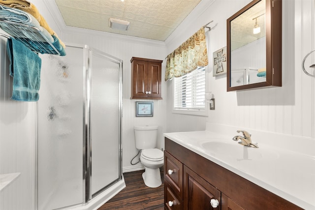 bathroom featuring vanity, crown molding, toilet, and an enclosed shower