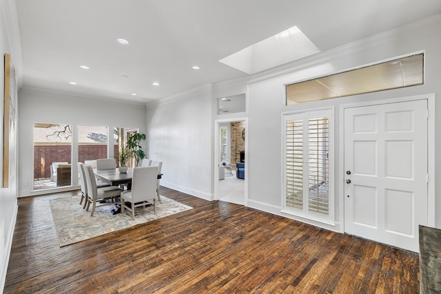 dining space featuring crown molding, dark wood-type flooring, and a skylight