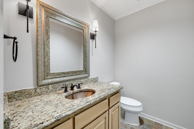 bathroom featuring vanity, ornamental molding, and toilet