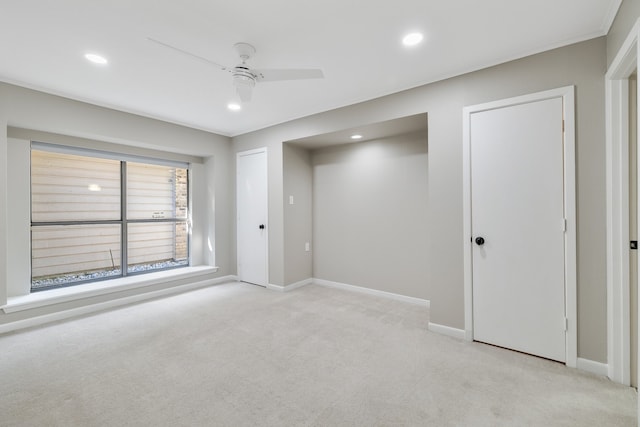 unfurnished bedroom with ceiling fan and light colored carpet