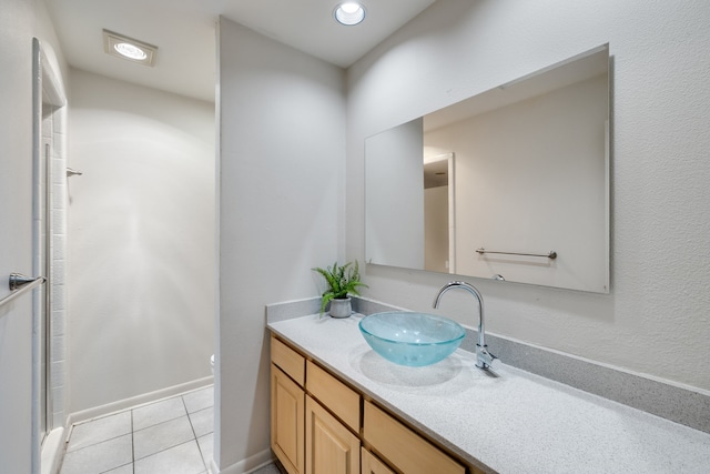 bathroom featuring tile patterned flooring, vanity, and a shower with door