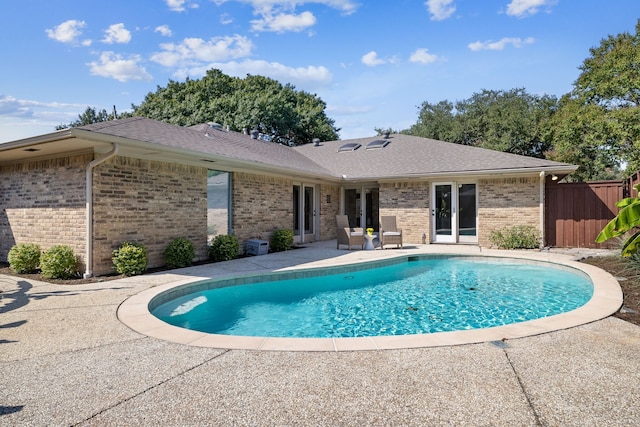 view of pool with a patio area and french doors