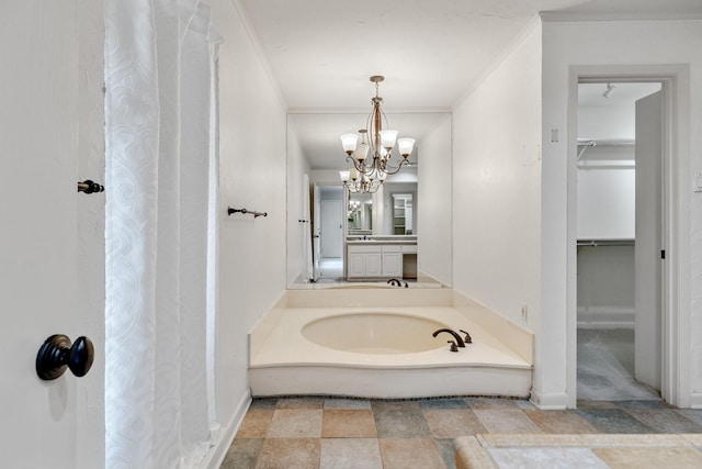 bathroom with a bath, an inviting chandelier, and crown molding