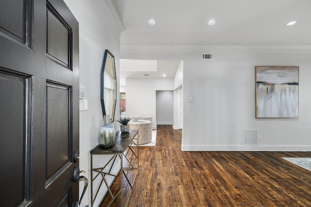 foyer entrance with dark hardwood / wood-style flooring and crown molding