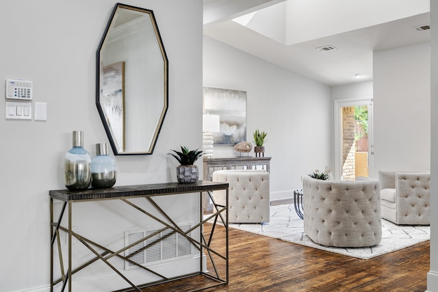 living area with hardwood / wood-style flooring and vaulted ceiling