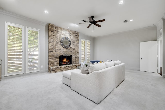 living room featuring light carpet, a brick fireplace, a wealth of natural light, and ceiling fan