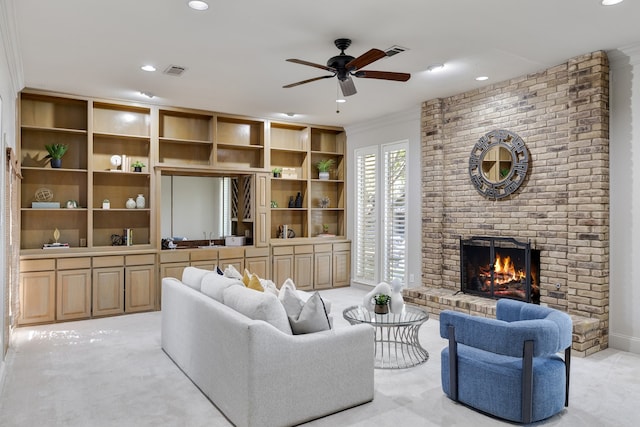 living room featuring ceiling fan, crown molding, a fireplace, and light carpet